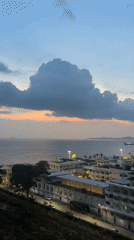 Dusk cityscape captured from Pattaya balcony with cloudy skies