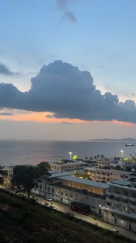 Dusk cityscape captured from Pattaya balcony with cloudy skies