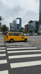 Street-level Seoul: taxis, deliveries, billboards, and a vintage car display