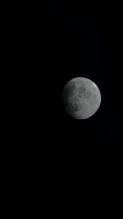 Bright moon observed through drifting clouds over Tbilisi