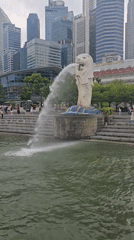 Tourist documents Marina Bay landmarks during cloudy Singapore morning