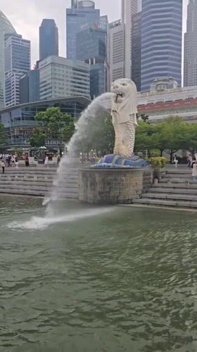 Tourist documents Marina Bay landmarks during cloudy Singapore morning