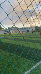Soccer match observed through fencing in Kuta Selatan, Indonesia