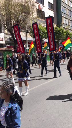 School groups parade through La Paz waving Bolivian flags
