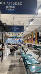 Passengers sleep on benches at Bangkok bus station