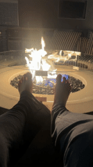 Late-night rooftop gathering around fire pit in Los Angeles
