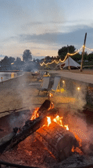 Evening beach resort scene with fires and lights in Votkinsk