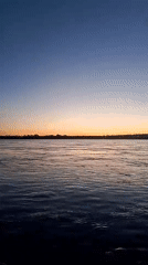 Evening fishing scene captured during sunset on Kama River