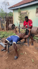 Men weightlifting with homemade equipment in Akwanga, Nigeria
