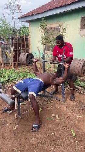 Men weightlifting with homemade equipment in Akwanga, Nigeria