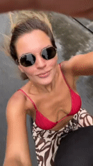 Woman films herself with camera in South Kuta
