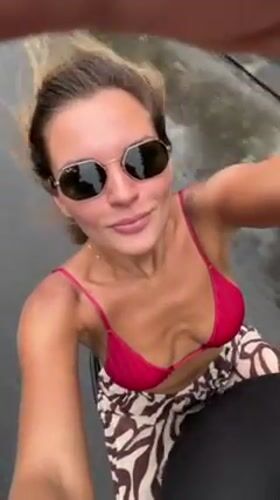 Woman films herself with camera in South Kuta