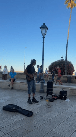 Sunny afternoon street life around Bari's historic waterfront