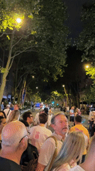 Paris crowd gathers near the Eiffel Tower on Bastille Day eve