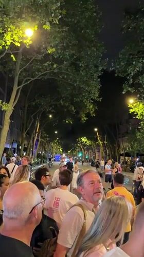 Paris crowd gathers near the Eiffel Tower on Bastille Day eve