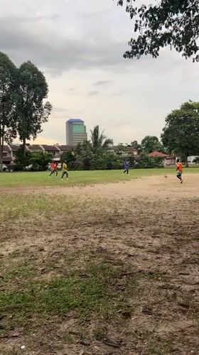Soccer game played on grassy field in Subang Jaya