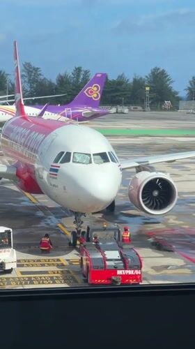 Phuket Airport tarmac activity on a rainy night