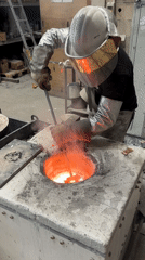 Worker operates furnace with molten material in French town