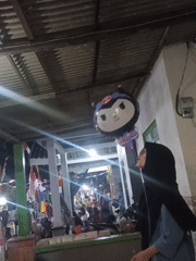 Nighttime village festival with traditional dance and parade in Jatigedong