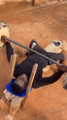 Man exercises on homemade log bench press in Nigeria
