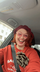 Woman in red beret drives through Yekaterinburg