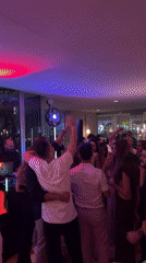 Tel Aviv bar or club buzzing with dancing and colored lights