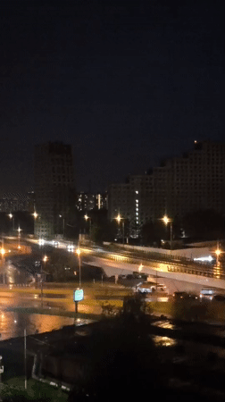 Rainy night cityscape with traffic captured by witness