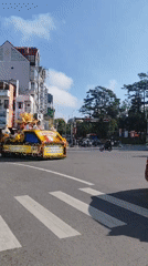 Buddhist procession with ornate float moves through Da Lat streets