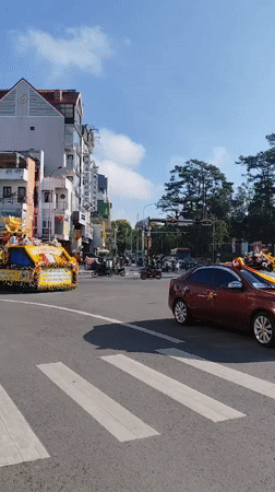 Buddhist procession with ornate float moves through Da Lat streets