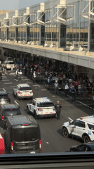Protest outside modern building in Philadelphia with police presence