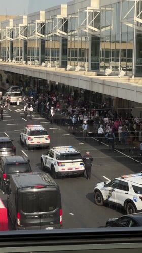 Protest outside modern building in Philadelphia with police presence