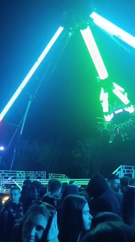 Illuminated carnival ride operates at Ruse fairground Friday evening