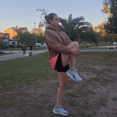 Woman stretches in Villa Domínico park during evening workout