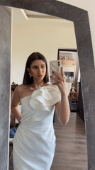 Woman takes mirror selfies in feathered dress, Sofia