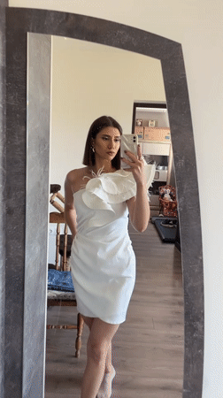 Woman takes mirror selfies in feathered dress, Sofia