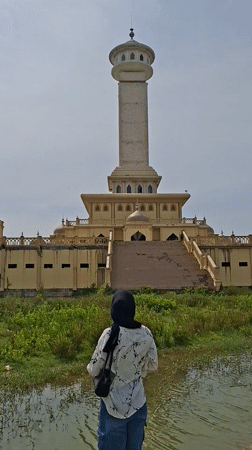 Visitors photograph Indonesian mosque complex from waterfront viewpoint