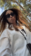 Woman films park selfie as bird perches nearby in Прикамский