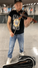 Violinist performs in underground concourse, location unknown