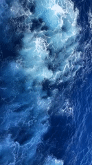 Ship wake creates foamy patterns in ocean waters