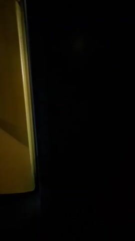 The video shows the inside of a refrigerator. The refrigerator is mostly empty, with a few items on the shelves. On the top shelf, there are two containers of food and a bag of something. On the middle shelf, there is a blue container and a bottle of ketchup. On the bottom shelf, there is a green bag of food. On the door of the refrigerator, there are a few bottles and jars. The refrigerator light is on.