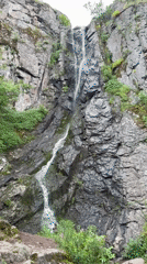 Tourists visit waterfall in Ustina, Bulgaria amid overcast skies