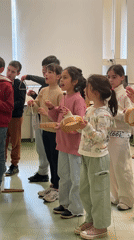 Children's music class with percussion instruments in French classroom