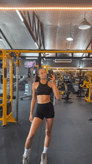 Woman takes gym mirror selfies in Chalong, Thailand