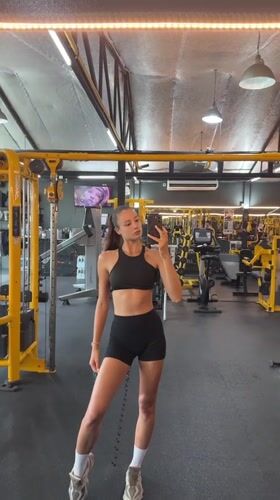 Woman takes gym mirror selfies in Chalong, Thailand