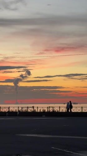 Sunset stroll along a Saint Petersburg waterfront promenade
