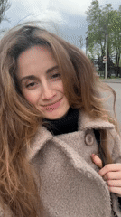 Woman filmed smiling in windy weather in Kryvyi Rih