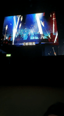 Concert performance displayed on large screen in London