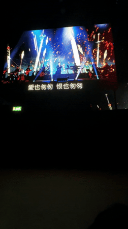 Concert performance displayed on large screen in London