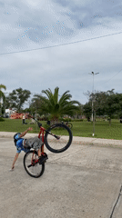 Youth performs bicycle tricks at Sarandí street fair