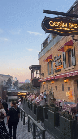 Baku's Sabail district at dusk: cobblestones, bold cars, local color
